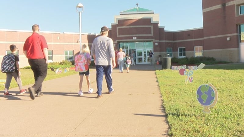 Students and parents walk into Northern Lights Elementary for the first day of school.