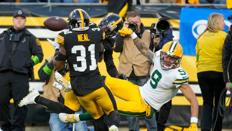 Pittsburgh Steelers' Keanu Neal intercepts a pass intended for Green Bay Packers' Christian...