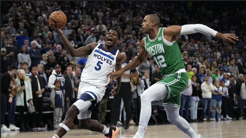 Minnesota Timberwolves guard Anthony Edwards (5) works toward the basket as Boston Celtics...