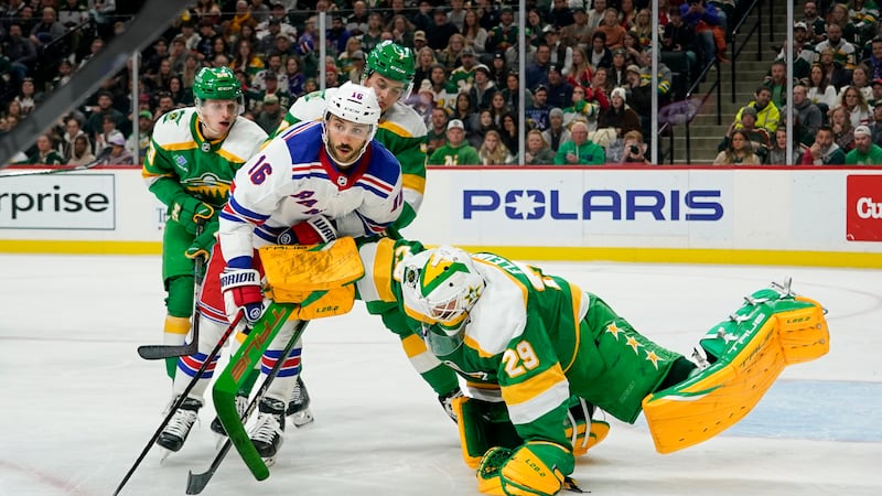 Minnesota Wild goalie Marc-Andre Fleury (29) covers the puck as he pushes away New York...