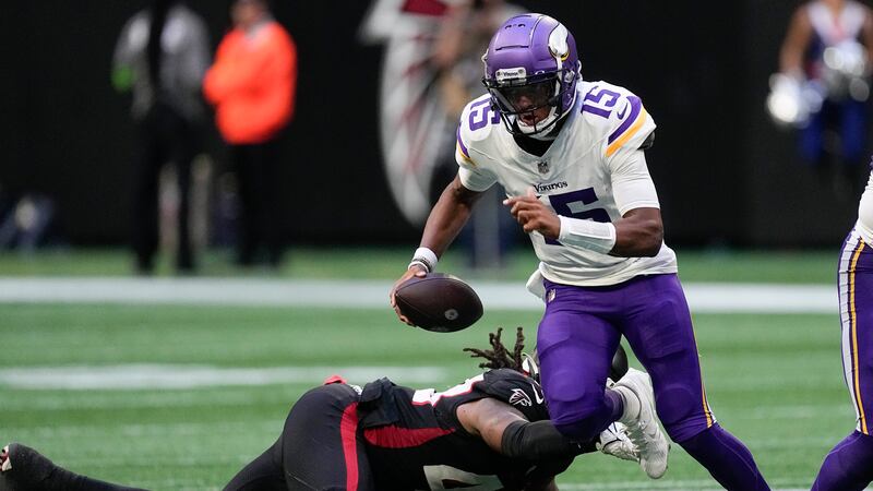 Minnesota Vikings quarterback Joshua Dobbs (15) runs for a first down past an Atlanta Falcons'...