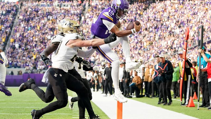 Minnesota Vikings quarterback Joshua Dobbs (15) runs for a touchdown during the first half of...