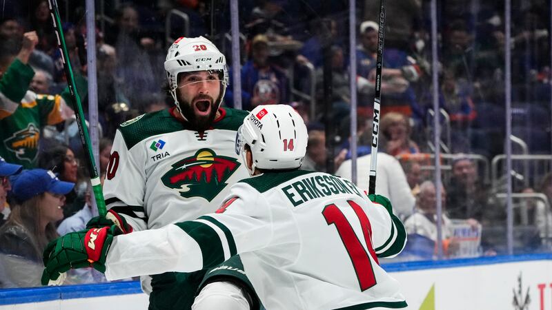 Minnesota Wild's Pat Maroon (20) celebrates with teammate Joel Eriksson Ek (14) after scoring...