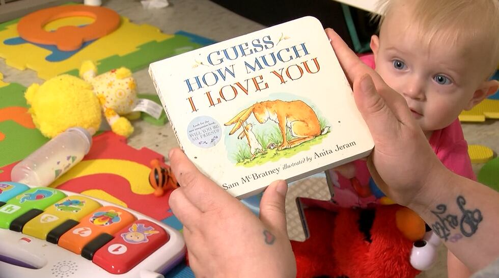 Taylor Hamilton reading to her daughters in their new home