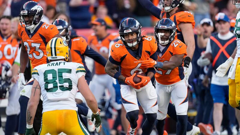 Denver Broncos safety P.J. Locke (6) is congratulated by cornerback Ja'Quan McMillian (29)...
