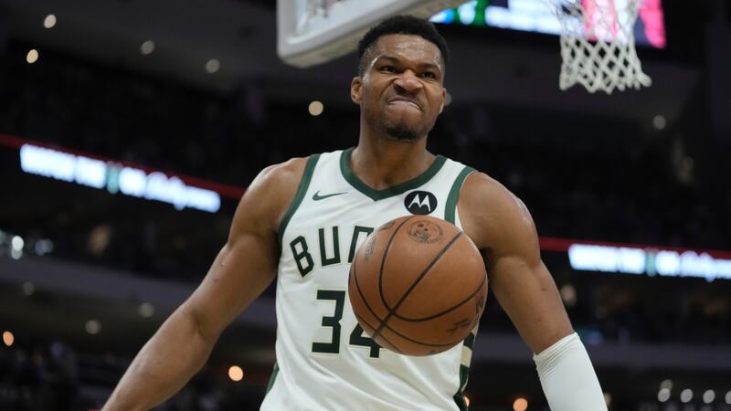 Milwaukee Bucks' Giannis Antetokounmpo reacts after a dunk during the first half of an NBA...